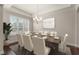 Elegant dining room featuring chandelier, dark hardwood floors, and set dining table at 970 Timberview Rd, Clermont, FL 34715