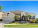Charming one-story home featuring stone accents, manicured landscaping, and a well-maintained lawn at 970 Timberview Rd, Clermont, FL 34715