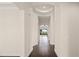 Hallway featuring dark hardwood floors, arched doorway, and view to outdoor living area at 970 Timberview Rd, Clermont, FL 34715