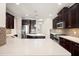 Bright kitchen showcasing quartz countertops, dark cabinetry, and stainless steel appliances at 970 Timberview Rd, Clermont, FL 34715