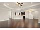 Open-concept living space with dark wood floors and seamless flow to the kitchen area at 970 Timberview Rd, Clermont, FL 34715