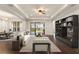 Inviting living room with stylish furniture, dark wood floors, and a built-in bookcase at 970 Timberview Rd, Clermont, FL 34715