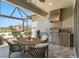 Outdoor kitchen and dining area with built in grill, sink, and refrigerator at 970 Timberview Rd, Clermont, FL 34715