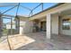 Screened in outdoor kitchen with a stainless grill, sink, and refrigerator at 970 Timberview Rd, Clermont, FL 34715