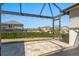Spacious screened patio perfect for enjoying outdoor living, featuring decorative stone tiles and a view of the yard at 970 Timberview Rd, Clermont, FL 34715