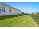 Well-maintained side yard with lush green lawn and trimmed hedge, offering privacy and curb appeal at 970 Timberview Rd, Clermont, FL 34715