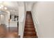 Wooden staircase with white banister leading from the kitchen and living area at 970 Timberview Rd, Clermont, FL 34715