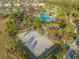 Drone view of community with a sand volleyball court, fire pit, pool, clubhouse, and winding sidewalks at 970 Timberview Rd, Clermont, FL 34715