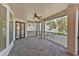 Covered balcony with brick floors and views of a quiet residential street at 9907 Beaufort Ct, Windermere, FL 34786