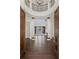 Grand foyer with soaring ceilings, columns, dark hardwood floors, and open doorway at 9907 Beaufort Ct, Windermere, FL 34786