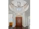 Foyer boasts soaring ceilings, decorative chandelier, and grand staircase at 9907 Beaufort Ct, Windermere, FL 34786
