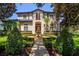 Elegant two-story home featuring a lush garden and fountain in the front yard at 9907 Beaufort Ct, Windermere, FL 34786