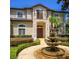Elegant two-story home featuring a beautifully landscaped front garden and fountain at 9907 Beaufort Ct, Windermere, FL 34786