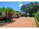 Four car garage with a large driveway and manicured landscaping at 9907 Beaufort Ct, Windermere, FL 34786