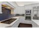 Chef's kitchen with stainless steel appliances, including a gas cooktop, oven and microwave at 9907 Beaufort Ct, Windermere, FL 34786