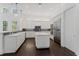 Modern kitchen features white cabinets, stainless appliances, and a spacious island at 9907 Beaufort Ct, Windermere, FL 34786
