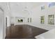 Bright living room with high ceilings, wood floors, modern chandelier and large windows at 9907 Beaufort Ct, Windermere, FL 34786