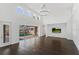 Spacious living room with hardwood floors and sliding glass doors leading to a pool area at 9907 Beaufort Ct, Windermere, FL 34786