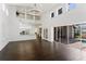 Open living space with a soaring ceiling, modern chandelier, and view of the kitchen at 9907 Beaufort Ct, Windermere, FL 34786