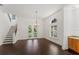 Sun-filled living room boasts hardwood floors, a modern chandelier, and easy access to the outdoors at 9907 Beaufort Ct, Windermere, FL 34786