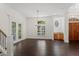 Bright living room featuring dark hardwood floors, French doors, and a stylish chandelier at 9907 Beaufort Ct, Windermere, FL 34786