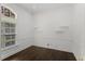 Minimalist office space with hardwood floors, ample natural light, and simple shelving at 9907 Beaufort Ct, Windermere, FL 34786