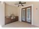 Outdoor kitchen with built-in grill and bar sink with access to the screened in pool at 9907 Beaufort Ct, Windermere, FL 34786