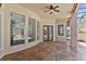 Covered patio features beautiful tile flooring and overlooks the screened in pool at 9907 Beaufort Ct, Windermere, FL 34786