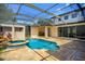 Enclosed pool with a hot tub and a built in outdoor grill area at 9907 Beaufort Ct, Windermere, FL 34786