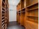 Large walk-in closet with custom wood shelving and hardwood floors at 9907 Beaufort Ct, Windermere, FL 34786