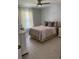 Bright bedroom featuring a large bed, neutral colors, natural light, and stylish decor at 9978 Tivoli Villa Dr, Orlando, FL 32829