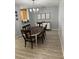 Dining room area with modern chandelier and wood flooring creates a cozy gathering spot at 9978 Tivoli Villa Dr, Orlando, FL 32829