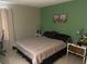Bedroom featuring decorative art, a queen-sized bed, and neutral-colored walls at 1001 Spring Meadow # 1001, Kissimmee, FL 34741