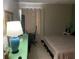 Bedroom features neutral tones, a comfortable bed, and a convenient desk area at 1001 Spring Meadow # 1001, Kissimmee, FL 34741