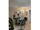 Dining room featuring a table with chairs, mirrors, and neutral-toned walls at 1001 Spring Meadow # 1001, Kissimmee, FL 34741
