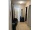 Hallway with neutral walls, doorframes, and tiled floors at 1001 Spring Meadow # 1001, Kissimmee, FL 34741