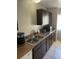 Kitchen featuring stainless steel sink, dark cabinetry, and laminate countertops at 1001 Spring Meadow # 1001, Kissimmee, FL 34741