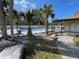Outdoor pool area with palm trees and a walkway, perfect for relaxation at 1001 Spring Meadow # 1001, Kissimmee, FL 34741