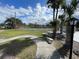 Outdoor tennis court surrounded by lush greenery, perfect for outdoor activity at 1001 Spring Meadow # 1001, Kissimmee, FL 34741