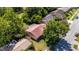 Aerial view of the property, highlighting its red tile roof and verdant landscaping at 10423 Manassas Cir, Orlando, FL 32821