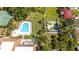 Aerial view of community pool, putting green, and common areas surrounded by lush landscaping and mature trees at 10423 Manassas Cir, Orlando, FL 32821