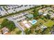 Aerial view showcasing community amenities: ample parking, boat storage, a pool, a putting green, and a tennis court at 10423 Manassas Cir, Orlando, FL 32821