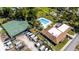 An aerial view of recreational amenities, featuring a pool, sports court, clubhouse, and boat storage area at 10423 Manassas Cir, Orlando, FL 32821