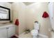 Cozy bathroom features neutral walls, tiled floors, shower, toilet, and vanity with a framed mirror at 10423 Manassas Cir, Orlando, FL 32821