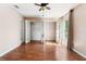 Bright bedroom with hardwood floors and open closet with shelves at 10423 Manassas Cir, Orlando, FL 32821