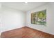 Clean bedroom showcasing wood-look floors and a large window for natural light at 10423 Manassas Cir, Orlando, FL 32821