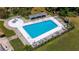 Aerial view of a community swimming pool with lounge chairs and picnic tables at 10423 Manassas Cir, Orlando, FL 32821