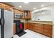 The kitchen features granite counters, wood cabinets, stainless steel appliances, and tile floors at 10423 Manassas Cir, Orlando, FL 32821