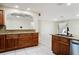 Well-lit kitchen with granite counters, wooden cabinets, stainless steel appliances, and open layout at 10423 Manassas Cir, Orlando, FL 32821