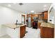 Well-appointed kitchen featuring granite counters, stainless appliances, and wood cabinets for modern living at 10423 Manassas Cir, Orlando, FL 32821